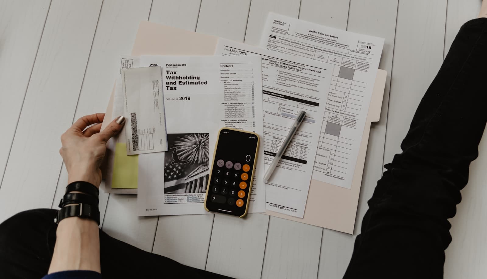 Person completing property tax paperwork at a desk